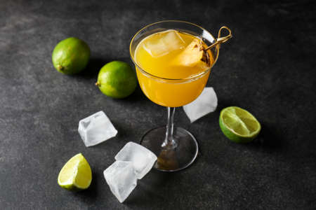 Glass of pineapple daiquiri cocktail on dark background