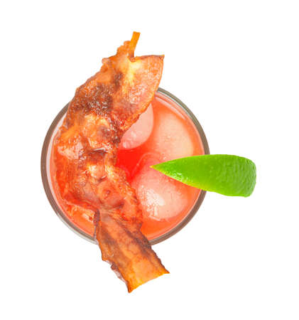 Glass of bloody mary cocktail garnished with bacon on white backgroundの写真素材