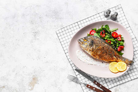 Plate with fried dorado on light backgroundの写真素材
