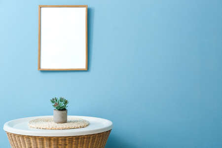 wooden frame hanging on color wall in living room
