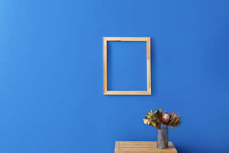 wooden frame hanging on color wall in living room