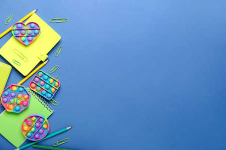 Popit fidget toys and stationery on color backgroundの写真素材