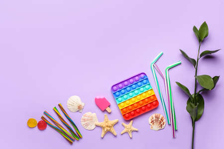 Composition with pop it fidget toy and sea shells on color background