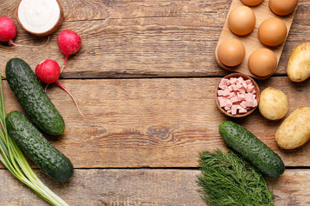 Different ingredients for okroshka on wooden backgroundの写真素材