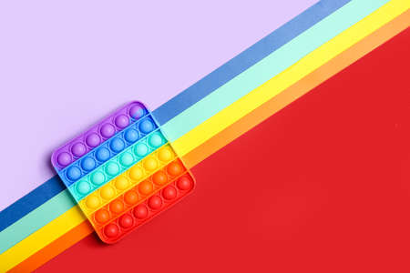 Rainbow pop it fidget toy on color backgroundの写真素材