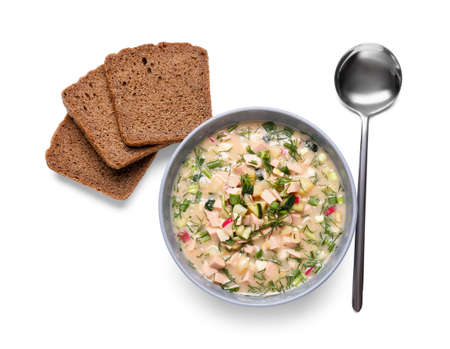 Bowl with tasty okroshka and bread on white background
