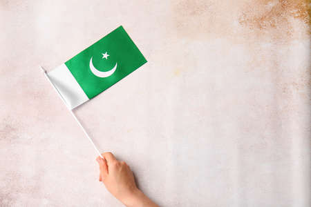 Female hand with Pakistan flag on grunge backgroundの写真素材