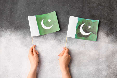 Female hands with Pakistan flags on black and white backgroundの写真素材