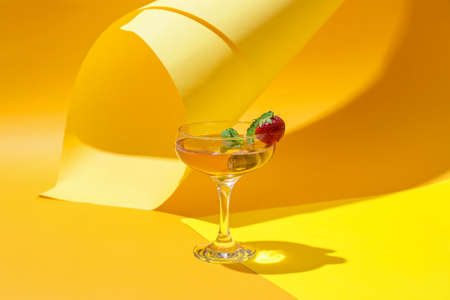 Glass of tasty cosmopolitan cocktail on color backgroundの写真素材