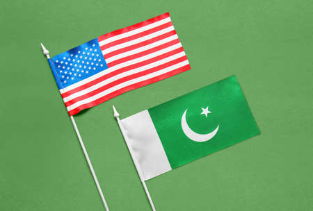 Flags of USA and Pakistan on color backgroundの写真素材