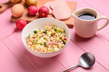 Bowl with different ingredients for okroshka on color wooden backgroundの写真素材
