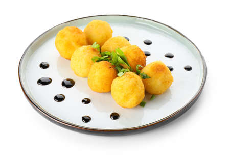 Plate with fried potato balls on white backgroundの写真素材