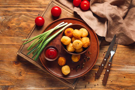 Composition with fried potato balls on wooden backgroundの写真素材