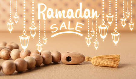 Wooden Muslim prayer beads and text RAMADAN SALE on color backgroundの写真素材