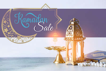 Muslim lamp, Koran and prayer beads on table. ramadan saleの写真素材