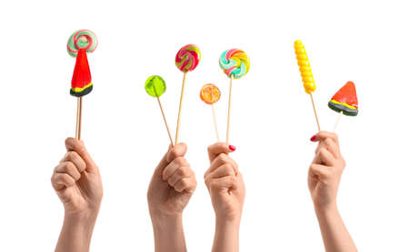 Women holding sweet lollipops on white backgroundの写真素材