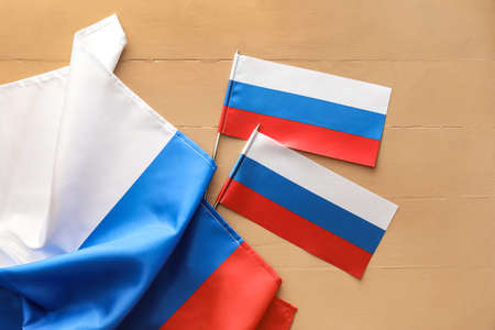 Russian flags on wooden background, closeup