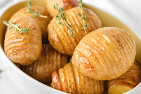 Dish with tasty baked potatoes, closeup