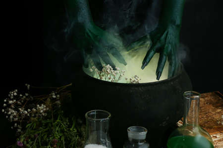 Evil witch making potion in cauldronの写真素材