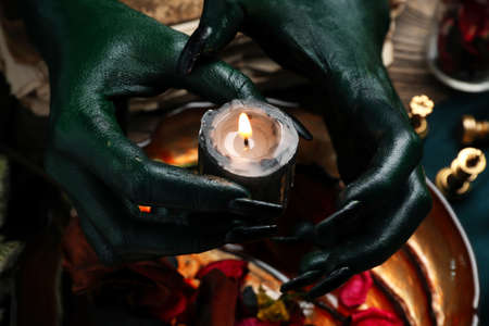 Evil witch performing ritual at table, closeupの写真素材