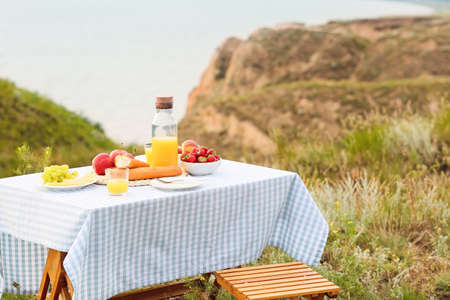 Table set for romantic picnic outdoorsの写真素材