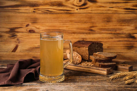 Mug of fresh kvass on wooden backgroundの写真素材
