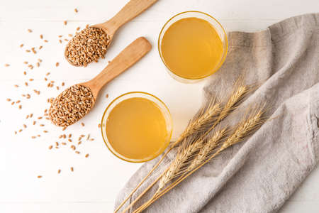 Glasses of fresh kvass on light backgroundの写真素材