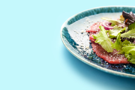 Plate with tasty veal carpaccio on color background, closeupの写真素材