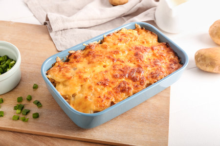 Baking dish with tasty potato casserole on light backgroundの写真素材
