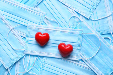 Red hearts on medical masks. Donation conceptの写真素材