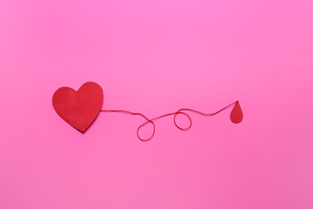 Red paper heart and drop of blood on color background. Donation conceptの写真素材