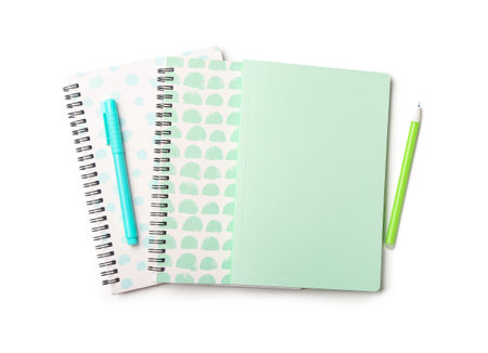 Stylish notebooks and pens on white backgroundの写真素材