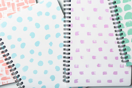 Stylish notebooks as background, closeup