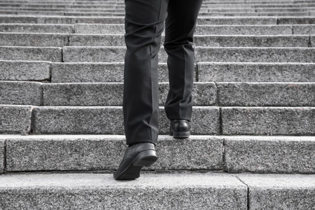 Businessman walking up the stairs outdoors