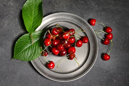 Bowl with sweet cherry on dark backgroundの写真素材