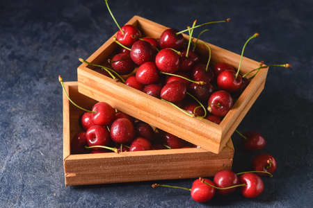 Boxes with sweet cherry on dark backgroundの写真素材
