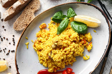 Plate with tasty pilaf on light backgroundの写真素材