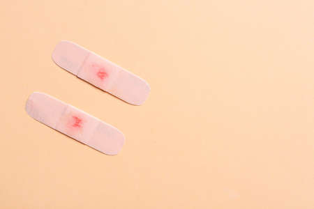 Medical plasters with drop of blood on color backgroundの写真素材