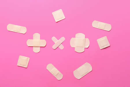 Beige medical plasters on color backgroundの写真素材