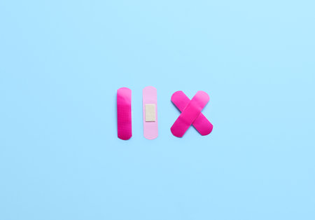 Pink medical plasters on color background