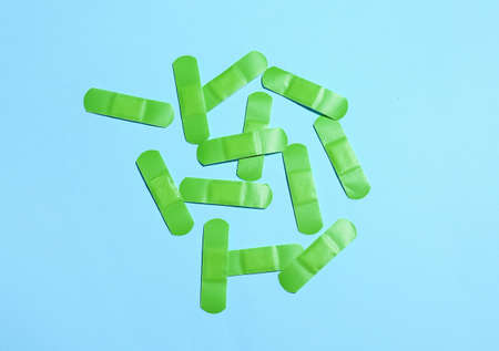 Green medical plasters on color backgroundの写真素材