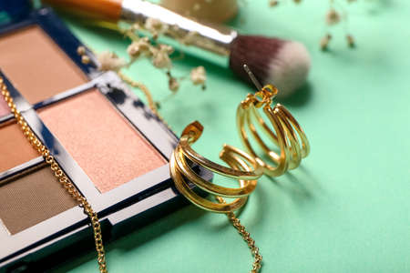 Stylish earrings on color background, closeup