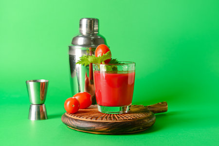 Board with glass of bloody mary on color backgroundの写真素材