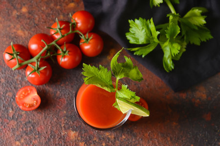 Glass of bloody mary with celery and tomatoes on grunge backgroundの写真素材