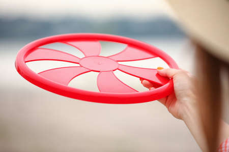 Young woman playing flying disk outdoors, closeupの写真素材