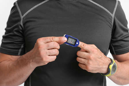 Male runner with pulse oximeter