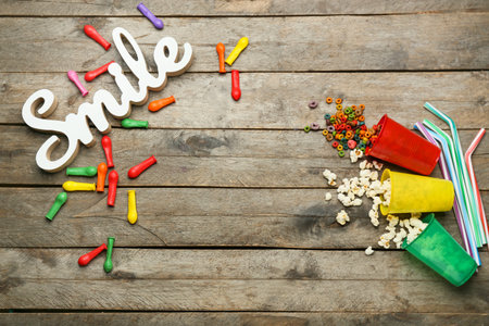 Composition with word SMILE, balloons, popcorn and cereal on wooden backgroundの写真素材