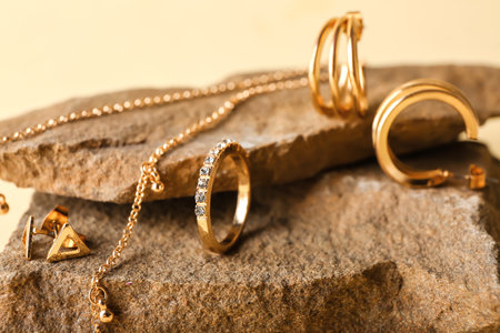 Granite stone with stylish jewelry on color background, closeupの写真素材