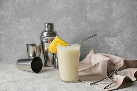 Glass with tasty Pina Colada cocktail on light backgroundの写真素材