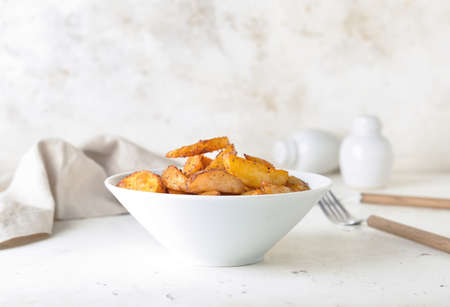 Bowl with tasty baked potato on tableの写真素材